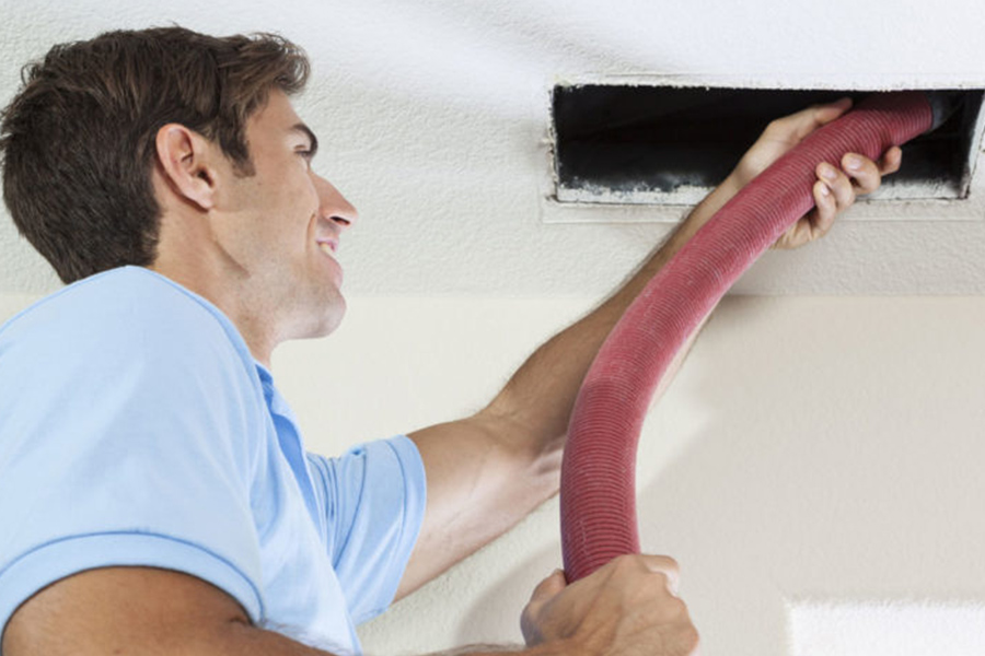 technician-cleaning-duct-from-residential-property-fresno-ca