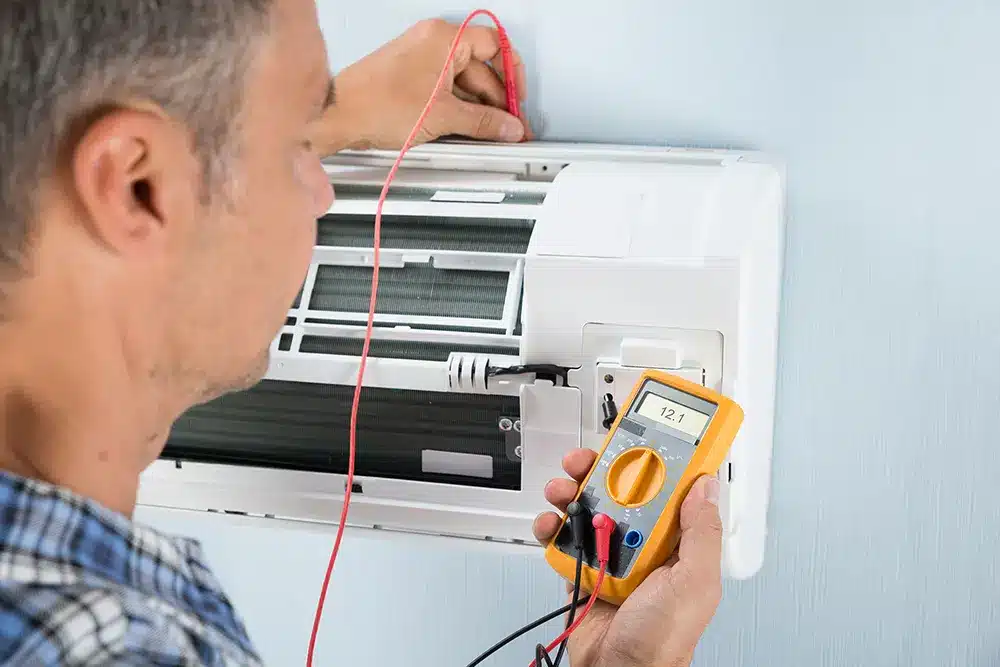 man-checking-air-conditioning-unit-fresno-ca